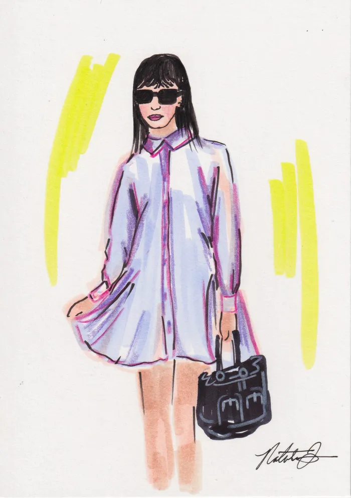 Fashion portrait of a woman in sunglasses and a pastel shirt dress carrying a black handbag