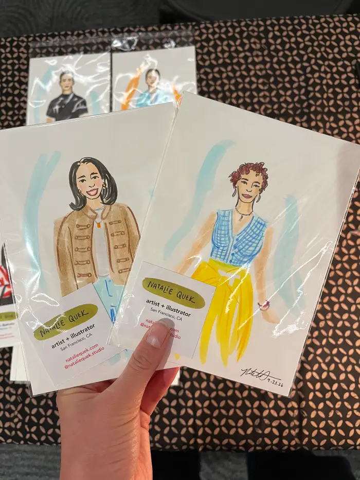 Two colorful guest fashion portraits held above the illustration table, featuring a tan jacket and a blue top with a yellow skirt